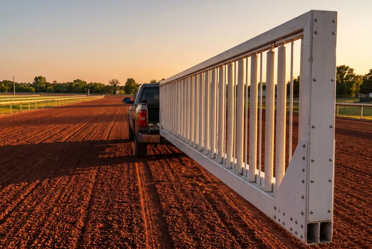 Mobile starting gate wing across an empty track at sunset